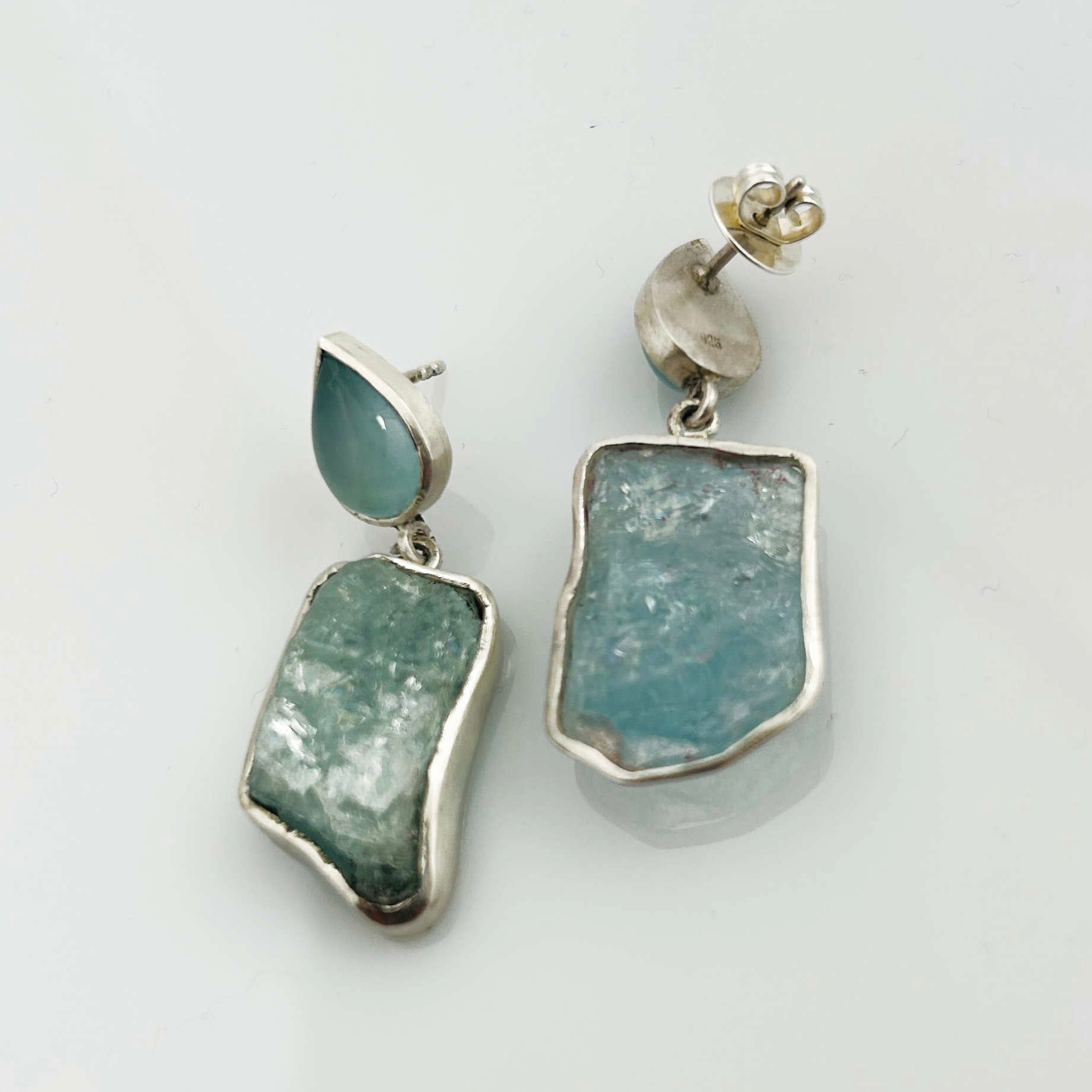 Detailansicht: Silber-Ohrstecker mit Aquamarintropfen und rohem Aquamarin